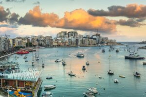 Sunset over Sliema Bay in Malta. Clouds and boats